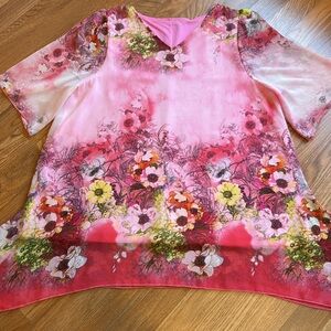Elegant pink chiffon floral with a half sleeve asymmetrical blouse. Size 1X.